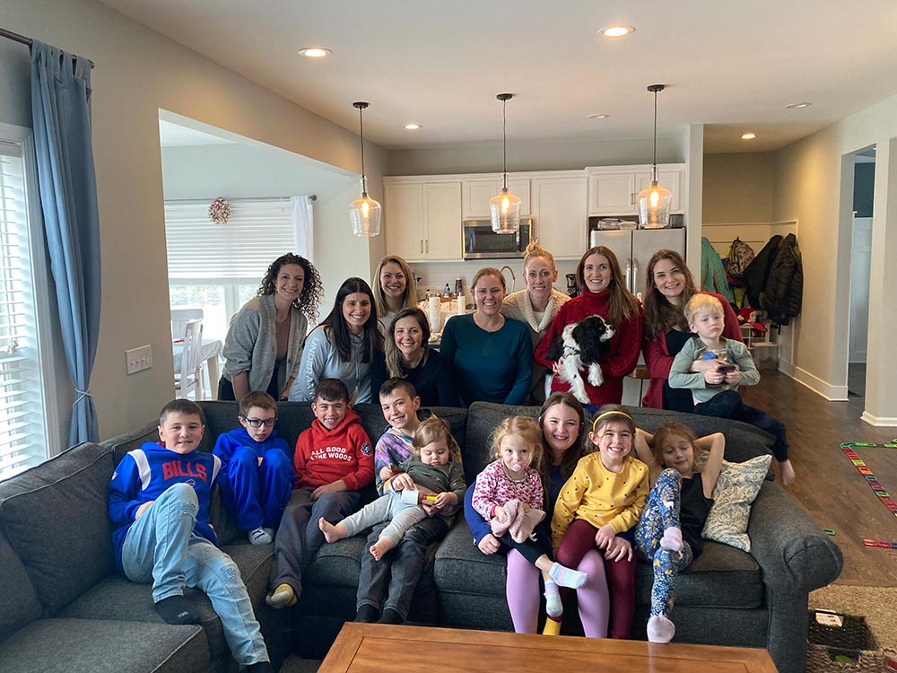 image of ladders wrapped in christmas tree lights with a dancer in white holding a peppermint